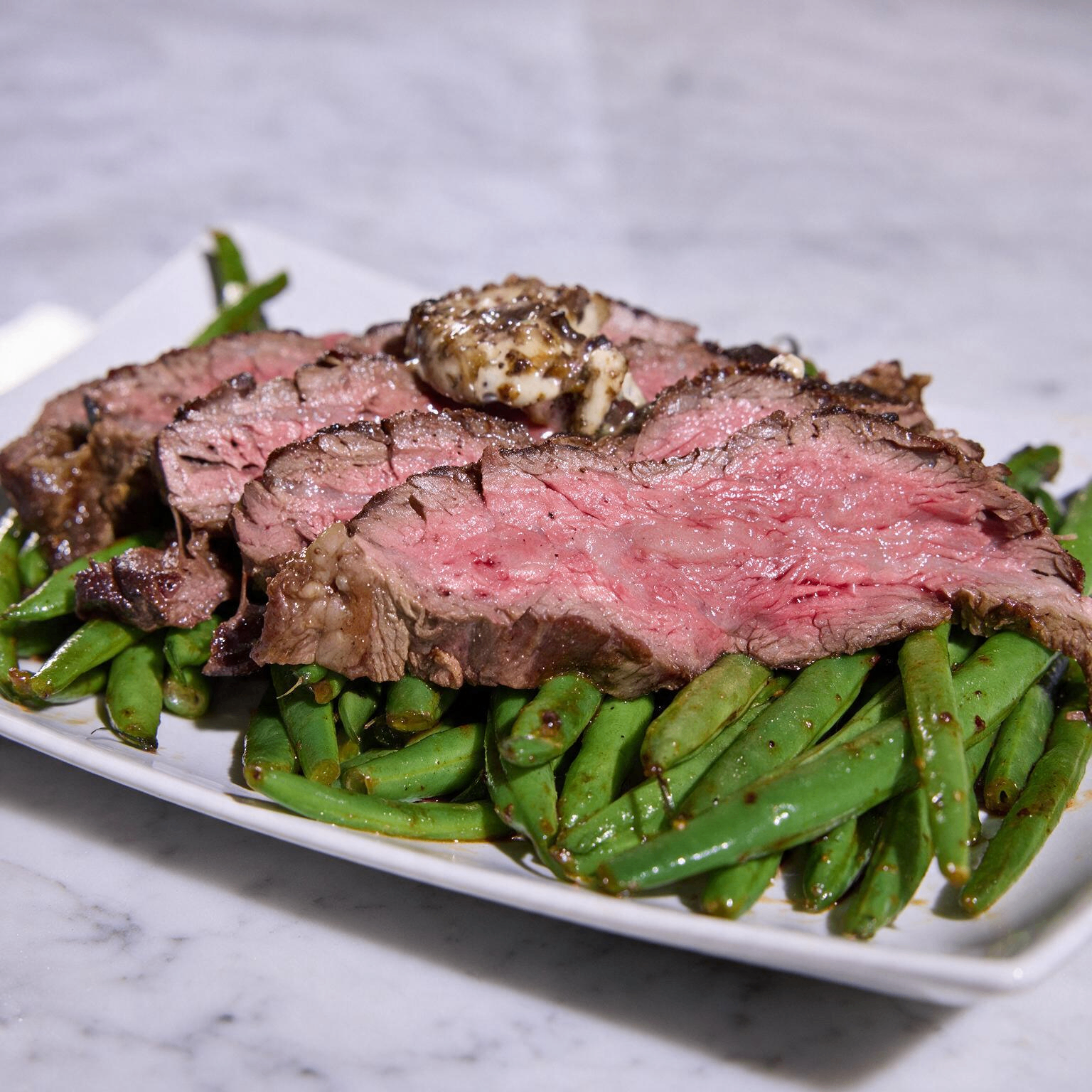 Seared Black Angus rib cap steak sliced into pinwheels